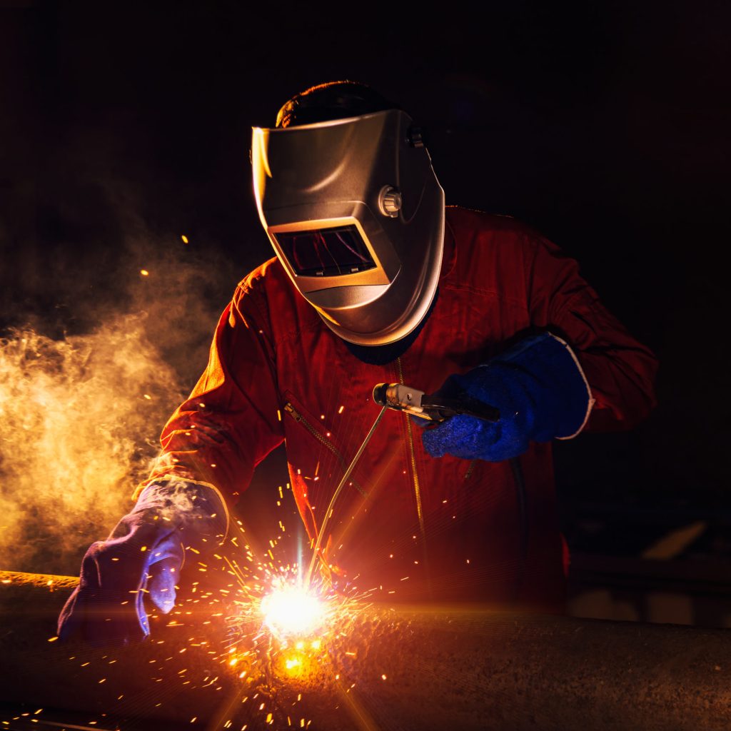 Industrial Worker at the factory welding closeup